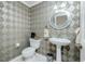 Small bathroom with pedestal sink and toilet at 1650 W Marion Ave # 144, Punta Gorda, FL 33950
