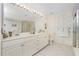 Double vanity bathroom with shower and decorative wallpaper at 1650 W Marion Ave # 144, Punta Gorda, FL 33950