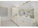Double vanity bathroom with large mirror at 1650 W Marion Ave # 144, Punta Gorda, FL 33950