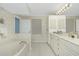 Double vanity bathroom with large mirror and bathtub at 1650 W Marion Ave # 144, Punta Gorda, FL 33950