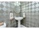 Small bathroom with pedestal sink and toilet at 1650 W Marion Ave # 144, Punta Gorda, FL 33950