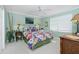 Bedroom with a floral comforter and ceiling fan at 1650 W Marion Ave # 144, Punta Gorda, FL 33950
