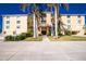 Attractive building exterior with landscaping and palm trees at 1650 W Marion Ave # 144, Punta Gorda, FL 33950