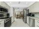 Open kitchen with stainless steel appliances and views to dining area at 1650 W Marion Ave # 144, Punta Gorda, FL 33950