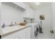 Laundry room with washer, dryer, sink, and cabinets at 1650 W Marion Ave # 144, Punta Gorda, FL 33950