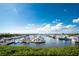 Tranquil marina with numerous boats and lush greenery under a vibrant sky at 1650 W Marion Ave # 144, Punta Gorda, FL 33950