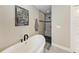 Spa-like bathroom featuring a soaking tub and a walk-in shower with pebble accents at 21341 Edgewater Dr, Port Charlotte, FL 33952