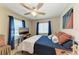 Cozy bedroom with a comfortable bed, ceiling fan, and plenty of natural light at 21341 Edgewater Dr, Port Charlotte, FL 33952