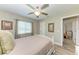 Serene bedroom featuring a queen bed, ceiling fan, and access to another room at 21341 Edgewater Dr, Port Charlotte, FL 33952