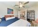 Bright bedroom with a queen-size bed, access to the kitchen, and built-in shelving at 21341 Edgewater Dr, Port Charlotte, FL 33952
