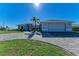 Modern home exterior with paver driveway and landscaping at 21341 Edgewater Dr, Port Charlotte, FL 33952