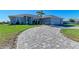 Single-story home with a paver driveway and landscaped yard at 21341 Edgewater Dr, Port Charlotte, FL 33952