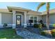 Front entrance with a walkway, landscaping, and a gray door at 21341 Edgewater Dr, Port Charlotte, FL 33952