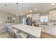 Spacious kitchen with white cabinets, stainless steel appliances and a large island at 21341 Edgewater Dr, Port Charlotte, FL 33952