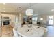 Open concept kitchen boasts modern white cabinets, stainless steel appliances, and a large island at 21341 Edgewater Dr, Port Charlotte, FL 33952