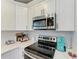 Kitchen detail showing stainless steel appliances and white cabinetry at 21341 Edgewater Dr, Port Charlotte, FL 33952