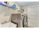 Well-equipped laundry room with washer, dryer, shelving, and utility sink at 21341 Edgewater Dr, Port Charlotte, FL 33952