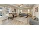 Spacious main bedroom with wood-look floors, ceiling fan, and access to the pool at 21341 Edgewater Dr, Port Charlotte, FL 33952