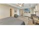 Main bedroom with wood-look floors, large TV, and plenty of natural light at 21341 Edgewater Dr, Port Charlotte, FL 33952