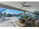 Spacious covered patio with pool, outdoor kitchen, and dining furniture at 21341 Edgewater Dr, Port Charlotte, FL 33952
