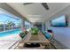Outdoor patio with pool, dining area, and flat-screen TV at 21341 Edgewater Dr, Port Charlotte, FL 33952