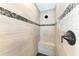 Large walk-in shower with pebble tile accents and built-in seat at 21341 Edgewater Dr, Port Charlotte, FL 33952