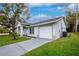 Beautifully landscaped home with a two-car garage and well-maintained lawn at 2190 Taunt St, Port Charlotte, FL 33948