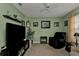 Home office with large TV and comfy chair at 2246 Jasmine Way, North Port, FL 34287