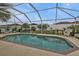 Relaxing screened-in pool area with lounge chairs and string lights at 2246 Jasmine Way, North Port, FL 34287