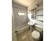 This bathroom features a toilet, pedestal sink, tub and shower combination, and tiled floors at 2273 Ednor St, Port Charlotte, FL 33952