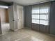 Simple bedroom with grey walls, tile floors and closet at 2273 Ednor St, Port Charlotte, FL 33952