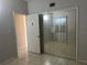 Bedroom with mirrored closet doors and access to another room at 2273 Ednor St, Port Charlotte, FL 33952