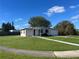 Ranch style home with a large yard, driveway, and mature trees at 2273 Ednor St, Port Charlotte, FL 33952