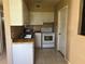 Small kitchen with white cabinets and a gas range at 2273 Ednor St, Port Charlotte, FL 33952