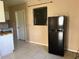 Galley kitchen with white cabinets and tile floors at 2273 Ednor St, Port Charlotte, FL 33952