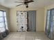 A room featuring tiled floors, ceiling fan, and curtains at 2273 Ednor St, Port Charlotte, FL 33952