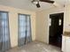 A room featuring tiled floors, ceiling fan, and curtains at 2273 Ednor St, Port Charlotte, FL 33952