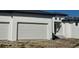 Three-car garage and front entrance of a new construction home at 24092 Potosi Ct, Punta Gorda, FL 33955