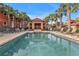 Community pool with covered cabana and lounge chairs at 3500 Mondovi Ct # 311, Punta Gorda, FL 33950