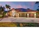 Beautiful house exterior at dusk, featuring a three-car garage and palm trees at 3600 Aruba Ct, Punta Gorda, FL 33950