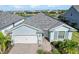 Single-story home with light blue exterior, two-car garage, and appealing curb appeal at 43015 Parkside Ct, Punta Gorda, FL 33982