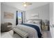 Bright bedroom with a comfy bed, chair, and natural light at 43015 Parkside Ct, Punta Gorda, FL 33982