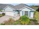 Single-story home with light blue siding, two-car garage, and solar panels at 43015 Parkside Ct, Punta Gorda, FL 33982