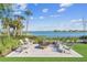 Relaxing fire pit area with lake views and Adirondack chairs at 43015 Parkside Ct, Punta Gorda, FL 33982