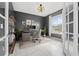 Stylish home office with built-in shelving and large window at 43015 Parkside Ct, Punta Gorda, FL 33982