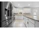 Sleek kitchen features stainless steel refrigerator and granite island at 43015 Parkside Ct, Punta Gorda, FL 33982