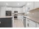 Bright kitchen boasts granite counters and stainless steel appliances at 43015 Parkside Ct, Punta Gorda, FL 33982