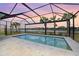 Enclosed pool and patio with lake view at 43015 Parkside Ct, Punta Gorda, FL 33982