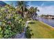 Landscaped waterfront property with canal views and lush vegetation at 116 Colonial Sw St, Port Charlotte, FL 33952