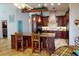 Spacious kitchen with granite counters, wooden cabinets, and an island at 116 Colonial Sw St, Port Charlotte, FL 33952